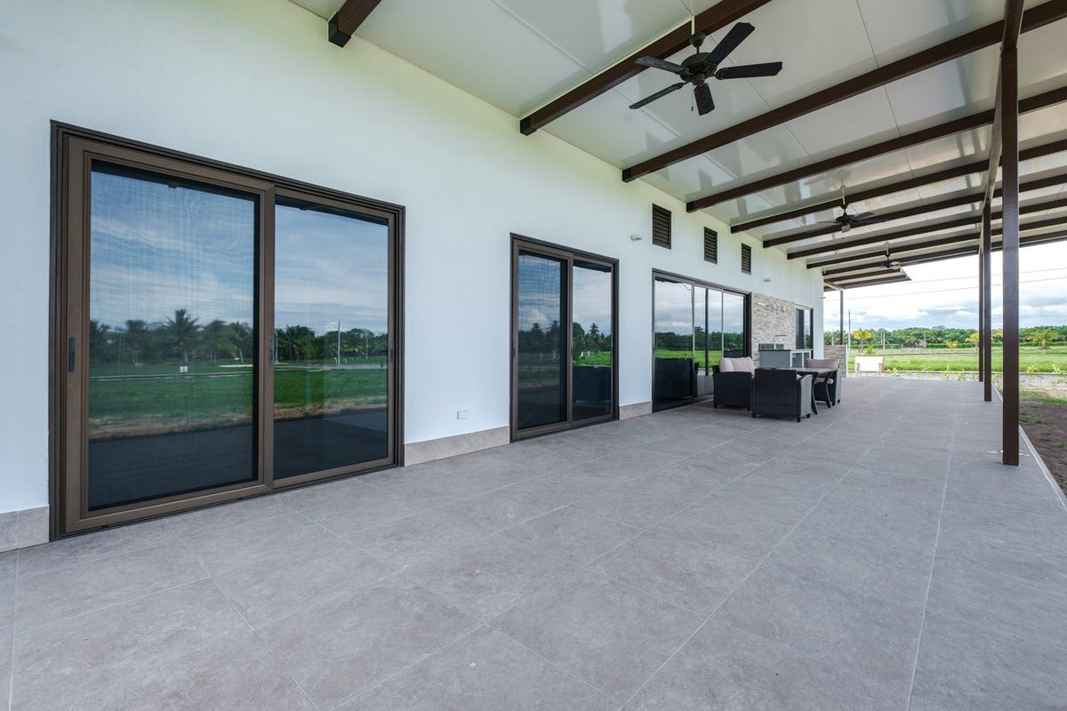 Sliding glass doors opening from CBV10 onto the covered terrace