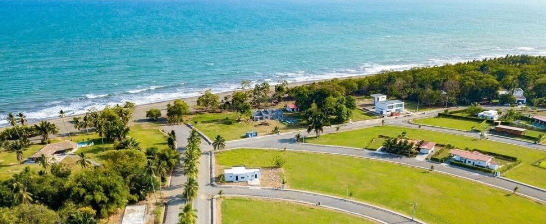 Aerial view of Coco Beach Community: roads, lots and homes beside the Pacific